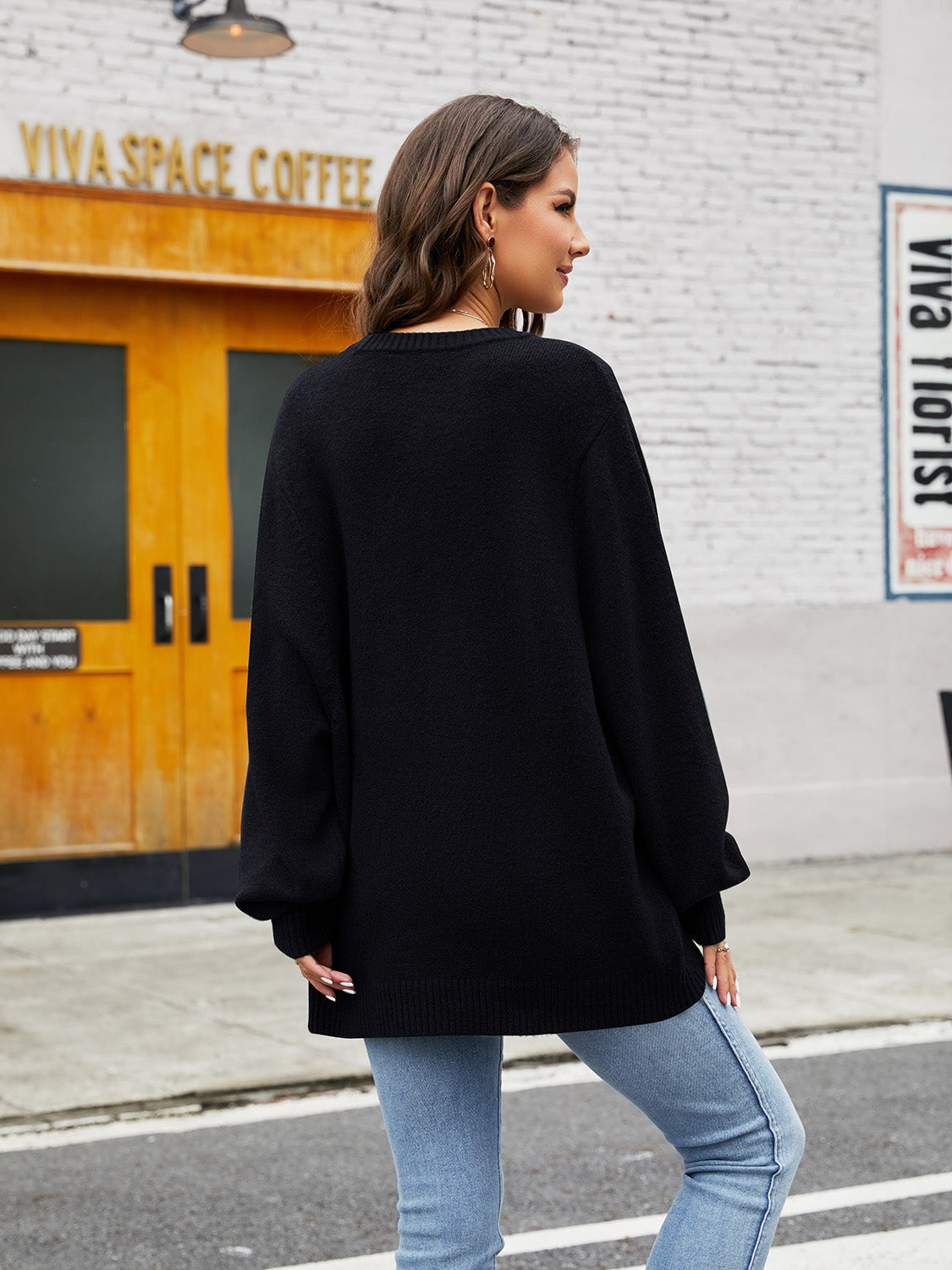 Black acrylic crewneck sweater with balloon sleeves and ribbed hem.