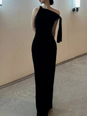 Black asymmetrical draped maxi dress with one shoulder and flowing detail.