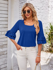 Royal blue blouse with square neckline and ruffled bell sleeves.