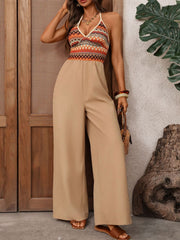 Geometric pattern halter jumpsuit with beige wide-leg pants.