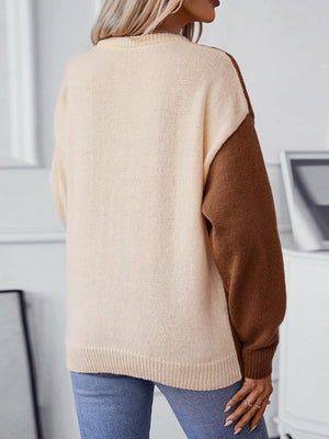 Colorblock cable knit raglan sweater in caramel and brown with ribbed trim.