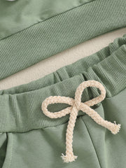 Green cotton baby outfit set with ribbed waistband and drawstring detail.