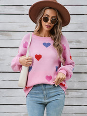 Pink acrylic knit sweater with allover heart motif and bubble sleeves