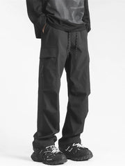Black loose fit cargo pants with drawstring waist and multiple pockets.