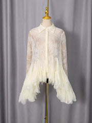 Apricot lace dress with ruffled hem and long sleeves.