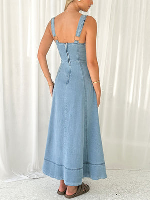 Light wash denim A-line midi dress with button details and contrast stitching.