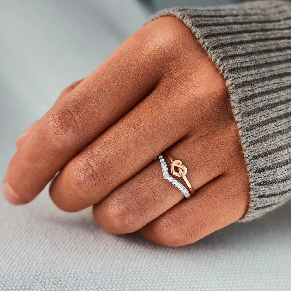 Silver knot and chevron zircon ring stack with pave diamonds