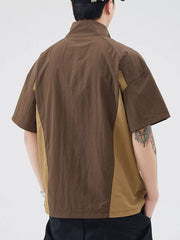 Lightweight outdoor pullover top in brown with tan colorblock detail, short sleeves, and stand-up collar.