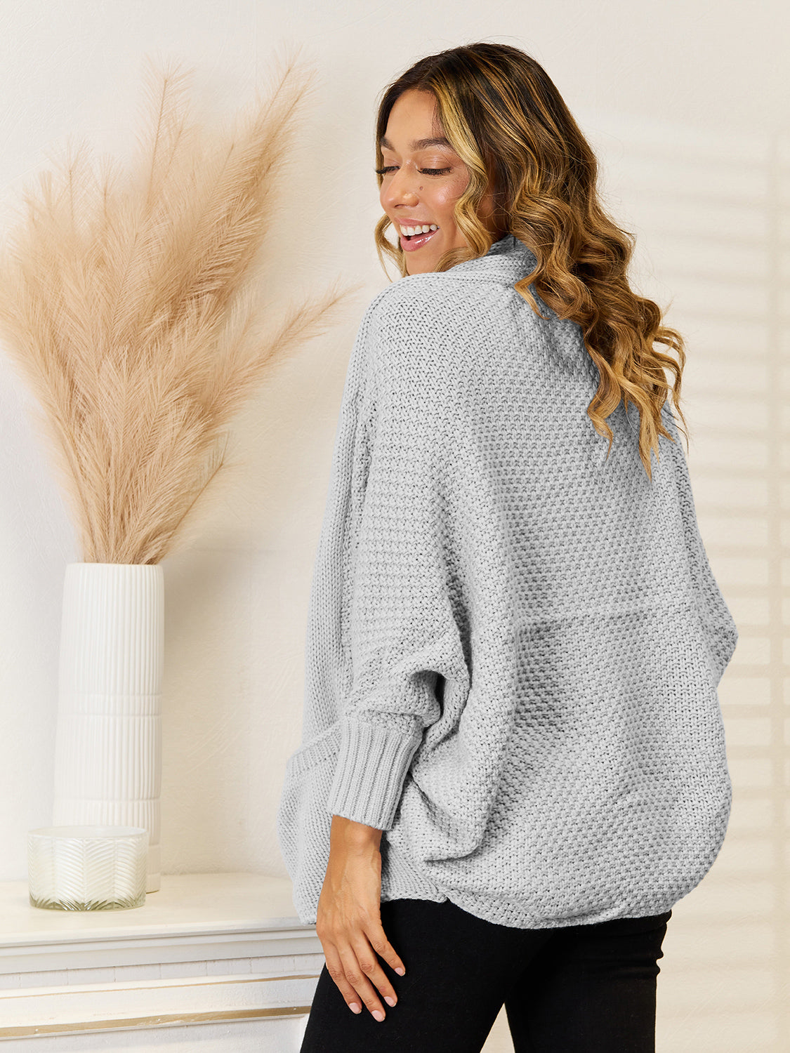 Cocoon knit cardigan in light gray with pockets and dolman sleeves.