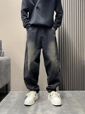 Men's oversized washed black tapered jeans with a baggy fit.