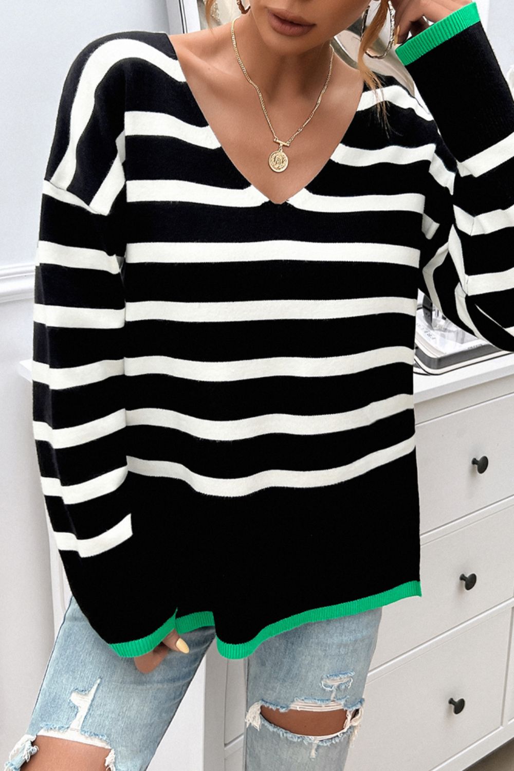 Oversized black and white stripe knit top with green trim and V-neck.