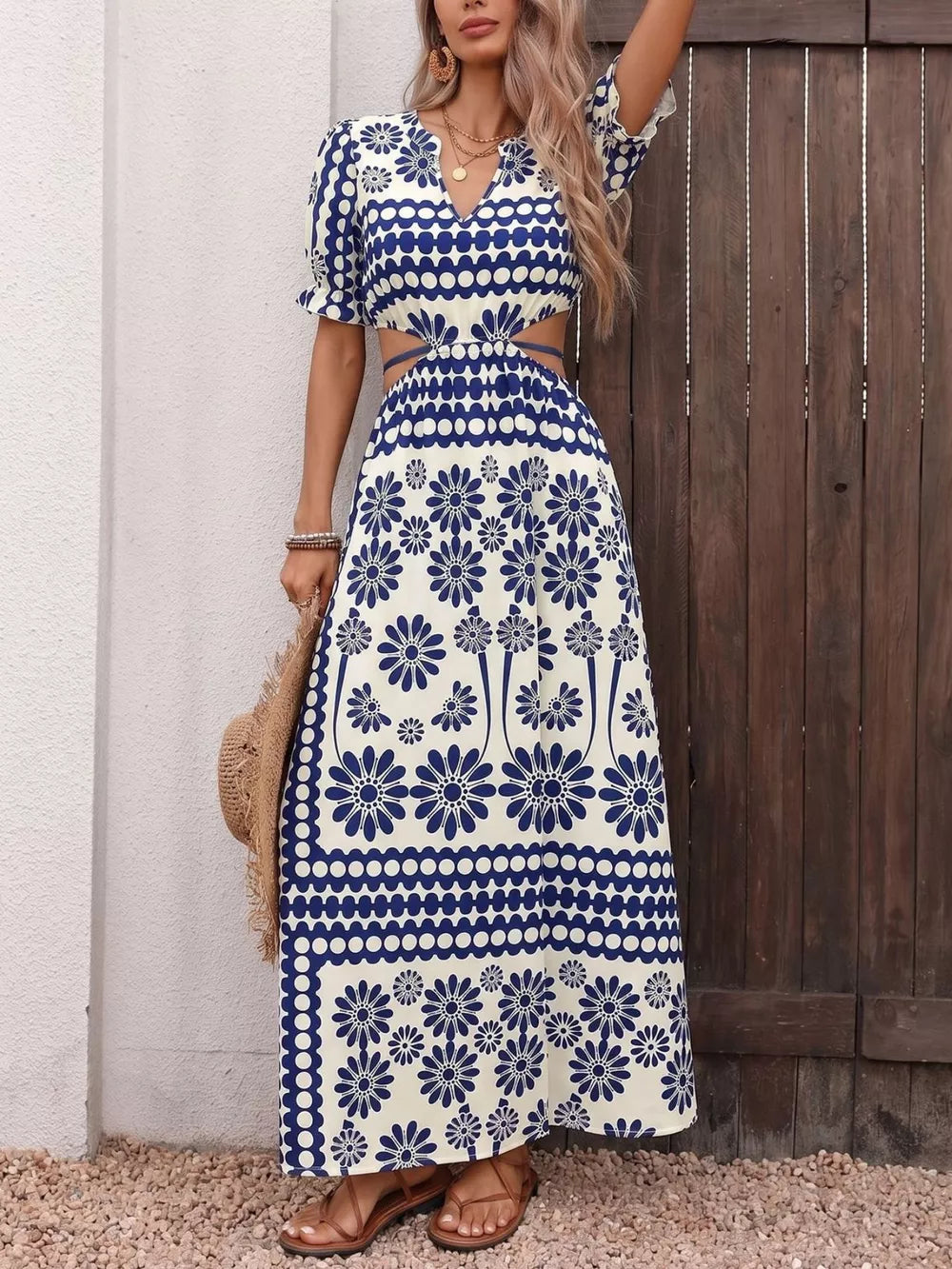 Maxi dress with blue floral print, cutout waist, v-neck, and short puff sleeves.
