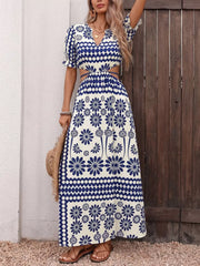 Maxi dress with blue floral print, cutout waist, v-neck, and short puff sleeves.