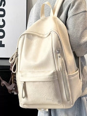 Chic white pu leather medium backpack with multiple zippered pockets and a cute dog charm.