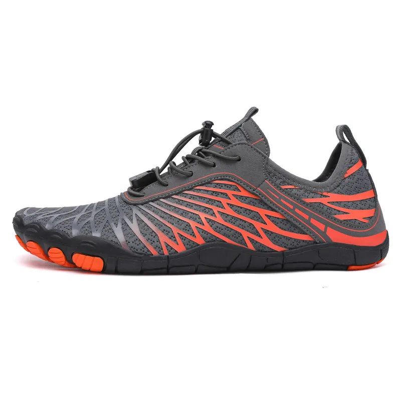 Adaptive mesh trail runners in grey with orange accents and quick-lace closure.