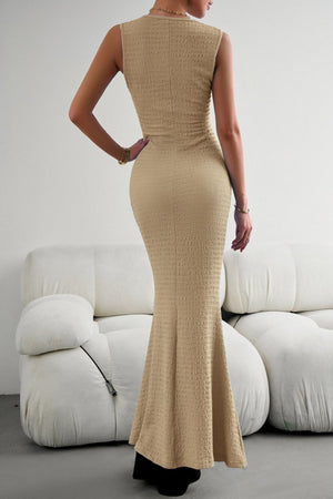 Sand textured maxi dress with a fishtail hem, sleeveless, and crew neck.