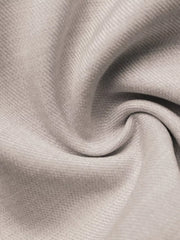 Luxe cami top in light beige fabric with subtle texture and a twisted detail.