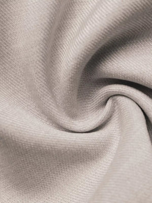 Luxe cami top in light beige fabric with subtle texture and a twisted detail.