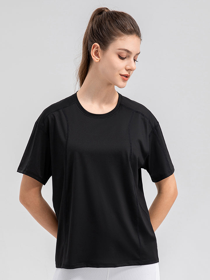 Black performance t-shirt with seam details and short sleeves.