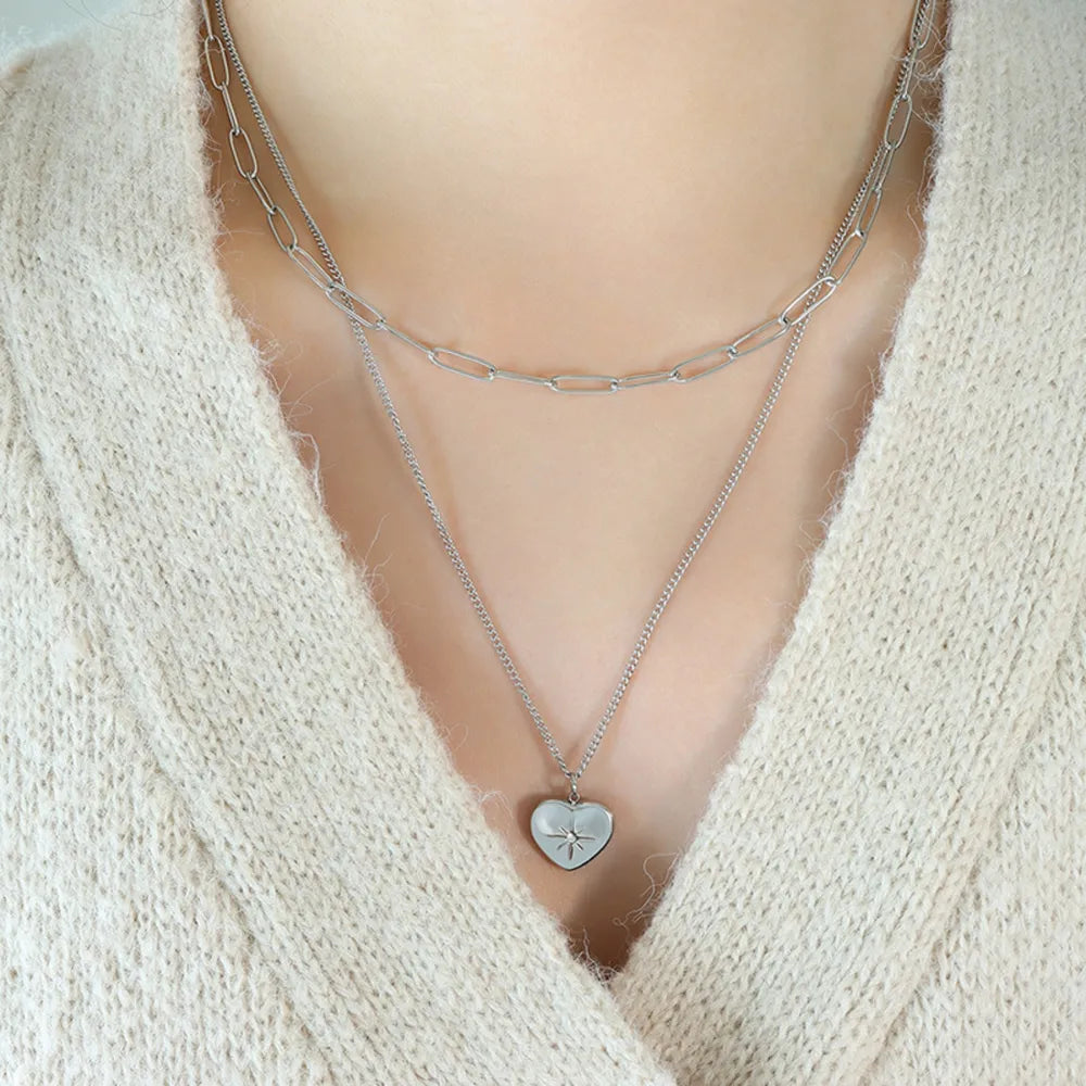 Silver layered necklace with paperclip chain and heart pendant with star detail