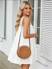 White tiered dress with lace yoke and crochet trim, sleeveless, relaxed fit