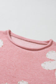 Blush pink knit sweater with pearl-embellished floral details and crew neck.