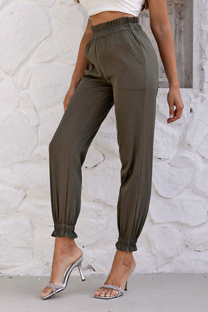 Olive brown gathered waistband cuffed jogger trousers with ruffled ankles.