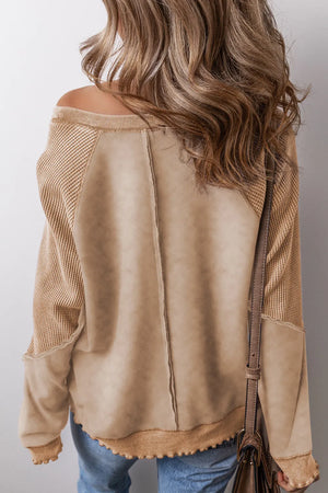 Tan waffle knit raglan sweatshirt with contrast paneling and raw edge hem.