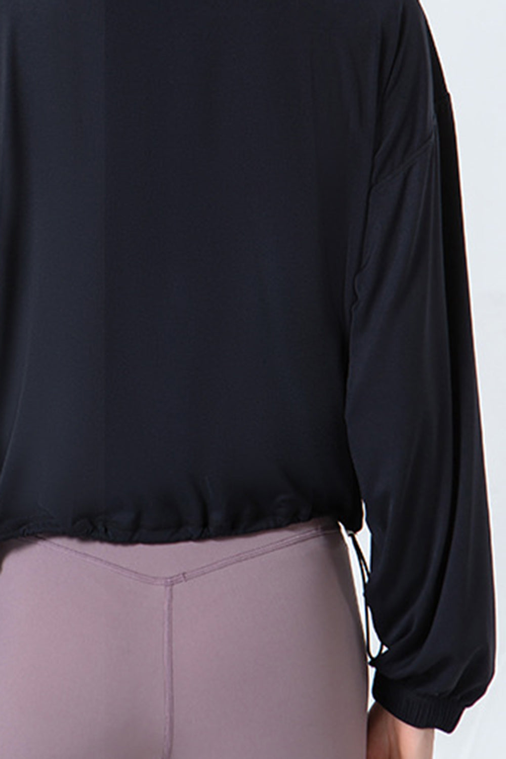 Black active jacket with gathered hemline and drawstring detail