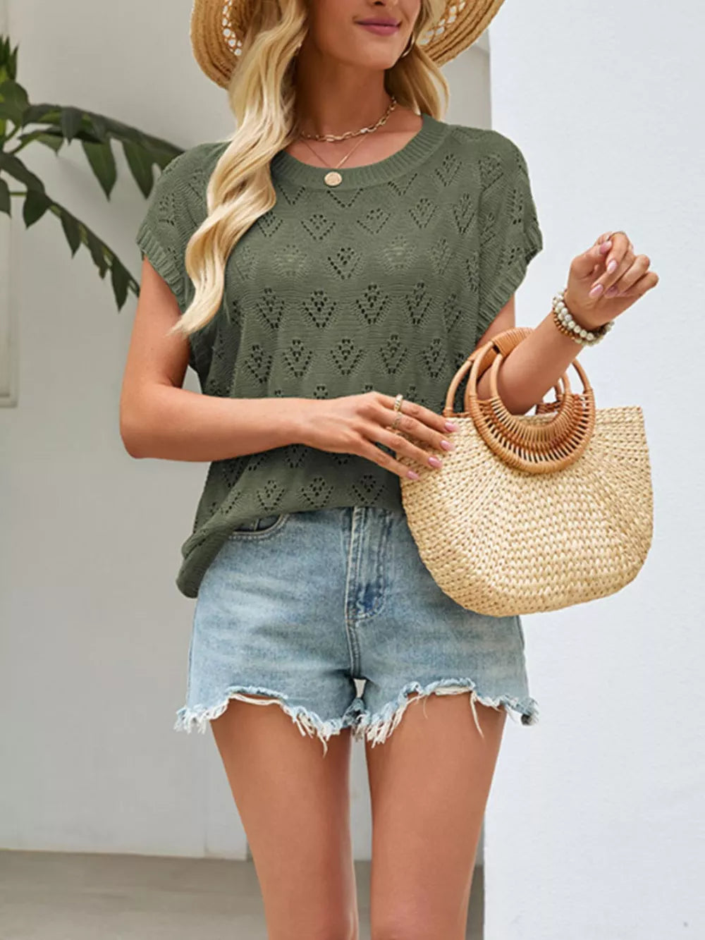 Green openwork knit top with diamond pattern, short sleeves, and crew neck.
