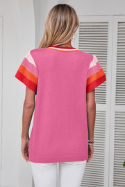 Pink knit blouse with colorblock trim on sleeves and neckline
