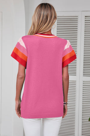 Pink knit blouse with colorblock trim on sleeves and neckline