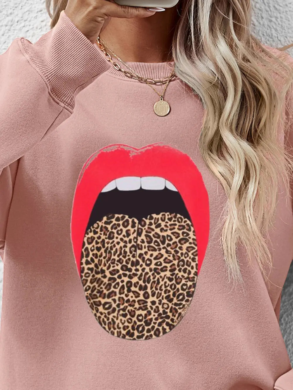Blush pink sweatshirt with a bold red lip and leopard tongue graphic.