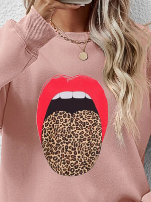 Blush pink sweatshirt with a bold red lip and leopard tongue graphic.
