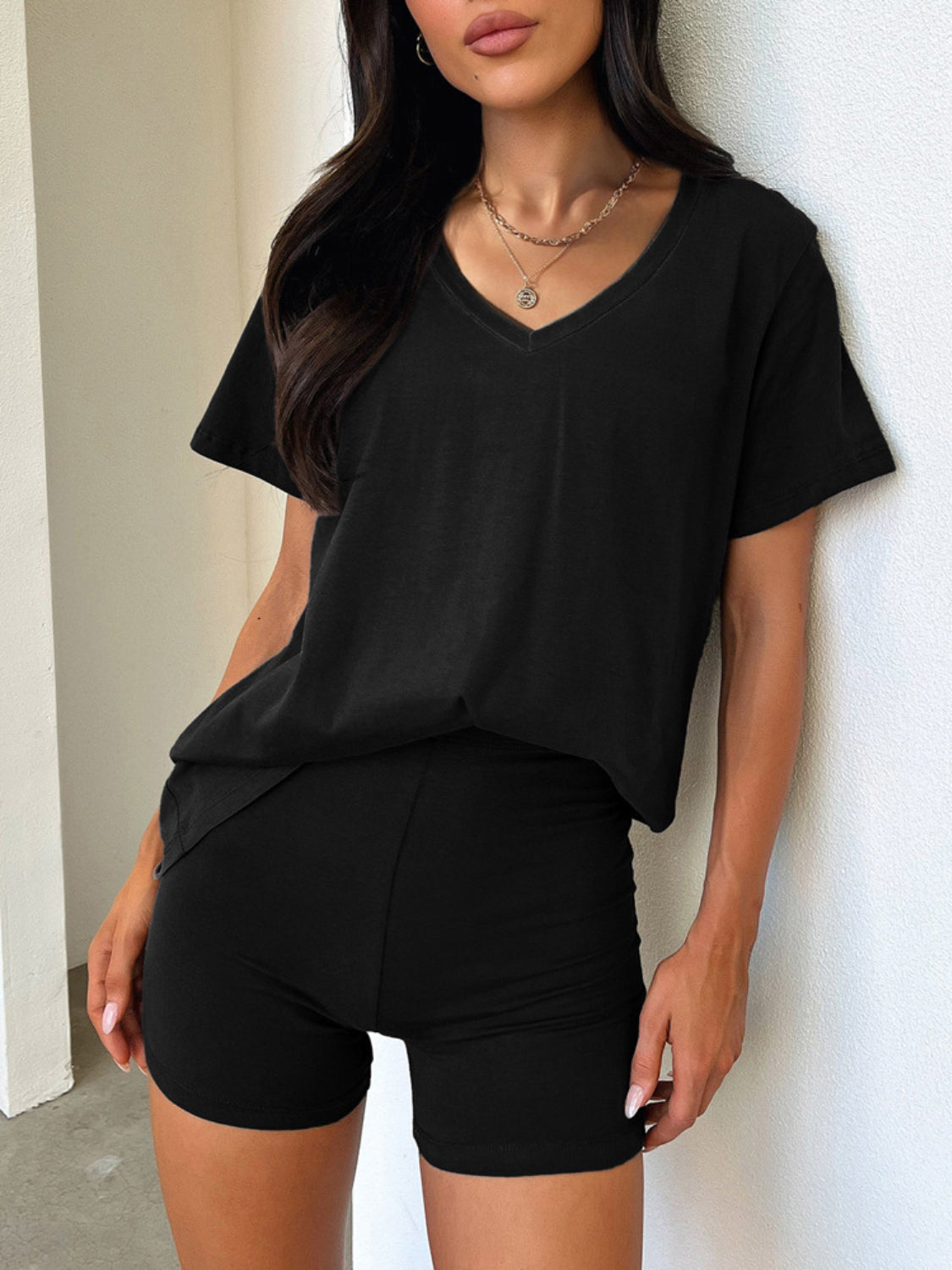 Black V-neck tee and biker shorts loungewear set with a relaxed fit.
