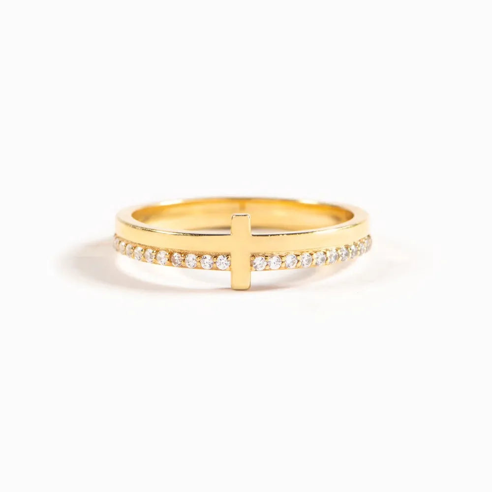 Gold ring with a cross and diamond trim detail