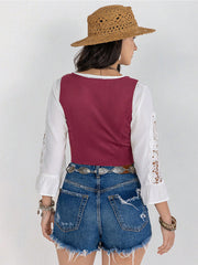 Cerise lace-up corset vest with white bell sleeves and lace detail, styled with denim shorts.