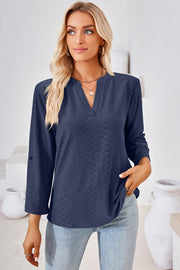 Textured henley shirt in dark blue with v-neck and roll-tab sleeves.