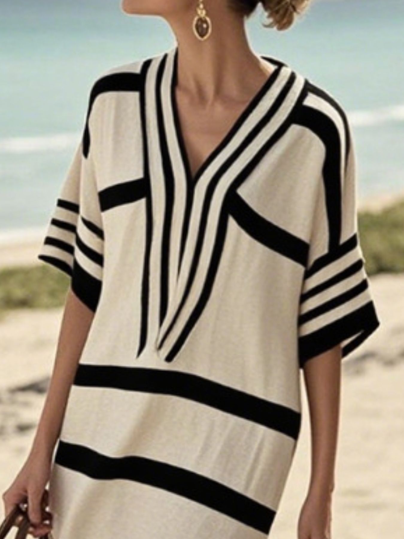 Striped midi dress with V-neck and half sleeves in black and tan.