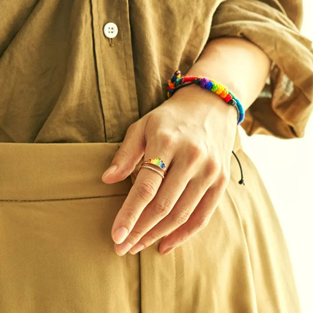 Rainbow prism stacked sterling rings in rose gold with colorful enamel detail.