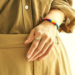 Rainbow prism stacked sterling rings in rose gold with colorful enamel detail.