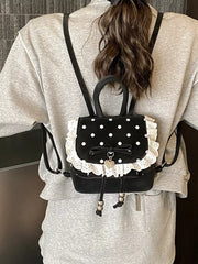 Black polka dot mini backpack with white lace trim and bow detail