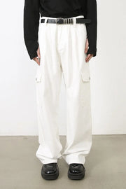 White 100% cotton pleated cargo pants with wide leg cut and utility pockets.