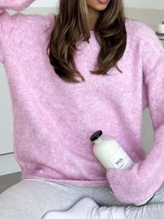 Pink cozy knit sweater with relaxed fit and crew neck, made of acrylic and cotton blend.