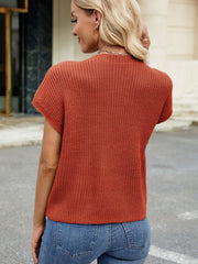 Knit cap-sleeve top in rust orange with ribbed texture and a mock neckline.