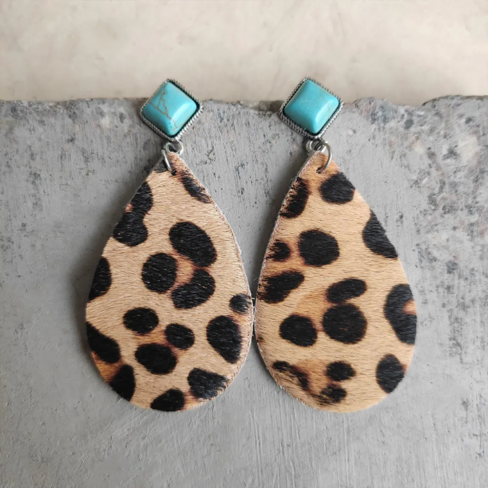 Leopard print teardrop earrings with turquoise square tops.
