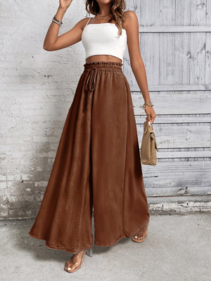 Brown palazzo trousers with ruffled waistline and drawstring, wide leg, and front slit.