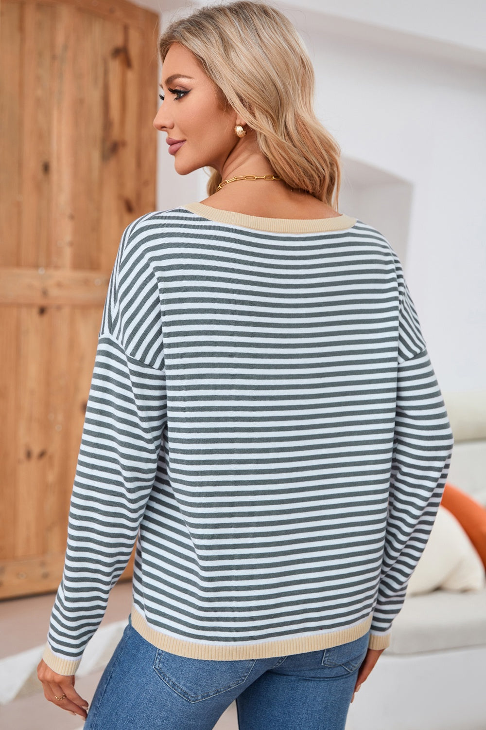 Nautical knit crewneck sweater with horizontal stripes and contrast trim neckline and hem.