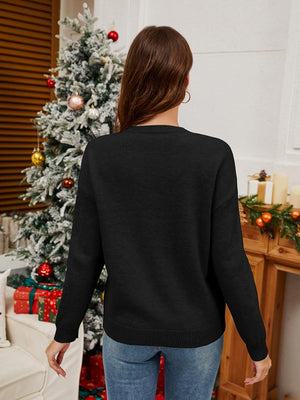 Black acrylic knit sweater with crew neck and long sleeves, festive holiday styling.