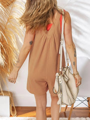 Textured gathered-yoke romper in coffee brown with V-neck and short legs.